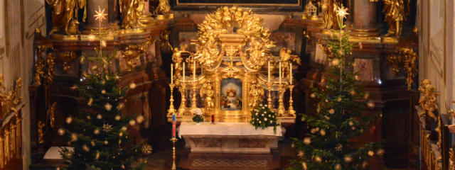 barocker Hochaltar mit geschmückten Christbäumen