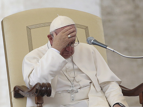 Papst Franziskus bei der Generalaudienz, bedeckt seinen Kopf mit einer Hand