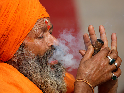 Ein Sadhu - heiliger Mann in Nepal beim Cannabisrauchen zum Fest Shivaratri
