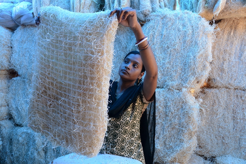 An Indian worker inspects a pad made of shredded wood fibre at an air cooler factory in Hyderabad