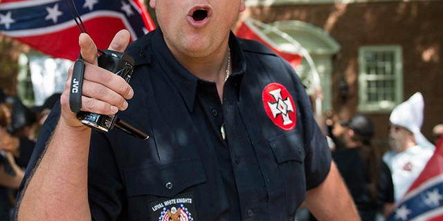 A member of the Ku Klux Klan shouts at counter protesters during a rally, calling for the protection of Southern Confederate monuments, in Charlottesville