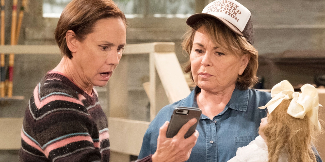 roseanne and jackie looking at a phone