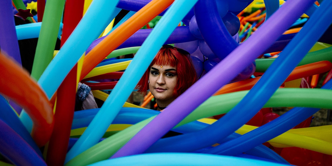 A participant looks through balloons during the 11th Gay Pride Parade in downtown Sofia