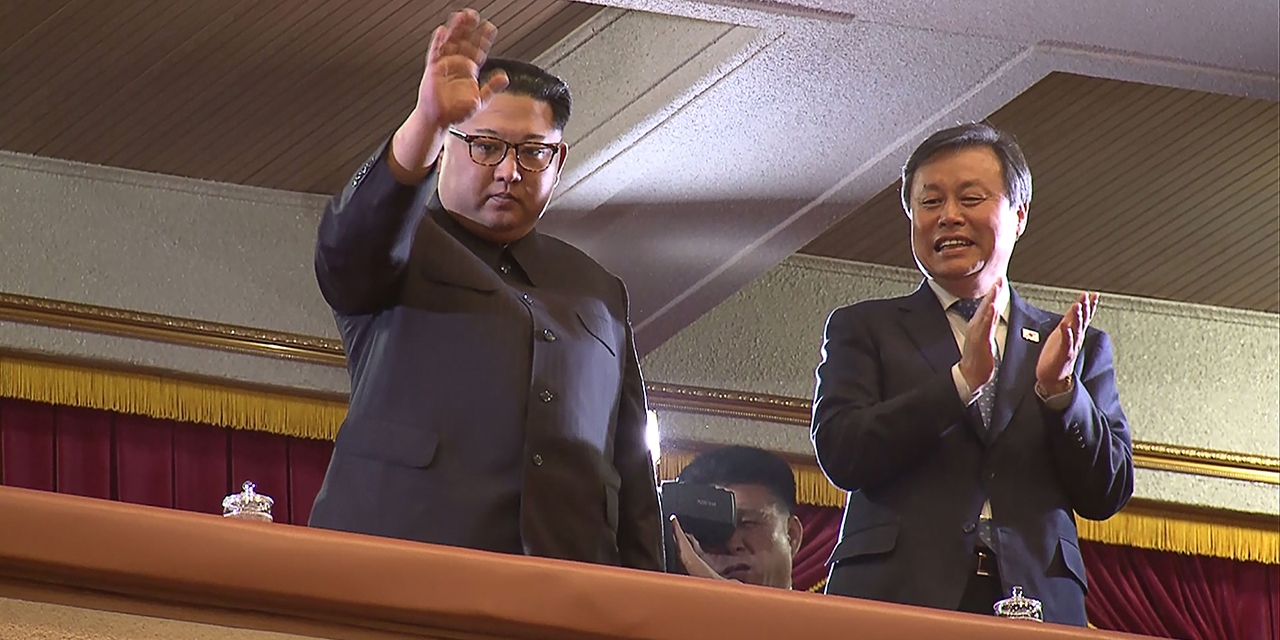 Kim Jong Un (L) and South Korea' s Culture, Sports and Tourism Minister Do Jong- whan (R) during a rare concert by South Korean musicians in Pyongyang on April 1, 2018