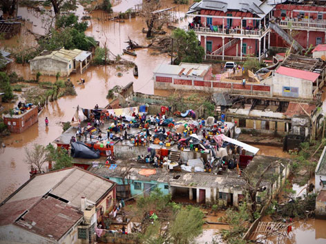 Menschen auf einem Dach in einem überfluteten Gebiet in Mosambik