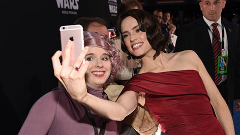 Daisy Ridley macht ein Selfie mit einem Fan am Roten Teppich bei der Star Wars IX Premiere