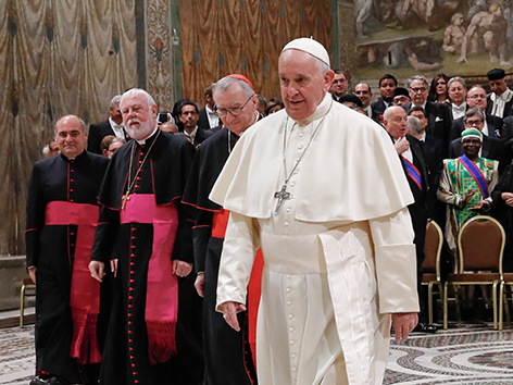 Papst Franziskus verlässt die Sixtinische Kapelle, hinter ihm Kardinäle und Diplomaten