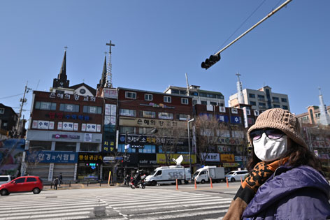 Eine Kirche in Seoul und eine Frau mit Maske