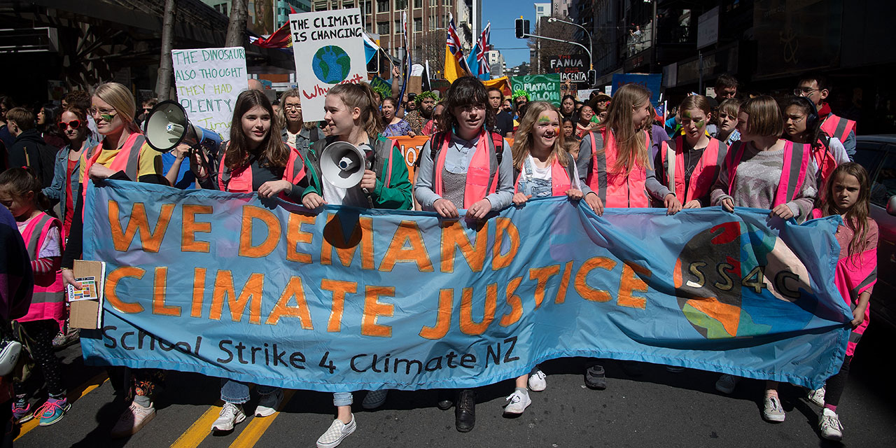 Protesters march to Parliament down Lampton Quay during a climate strike protest march in Wellington on September 27, 2019.