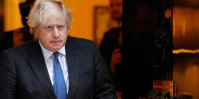 Britain's Prime Minister Boris Johnson walks out to meet Oman's Sultan in Downing Street in London on December 16, 2021