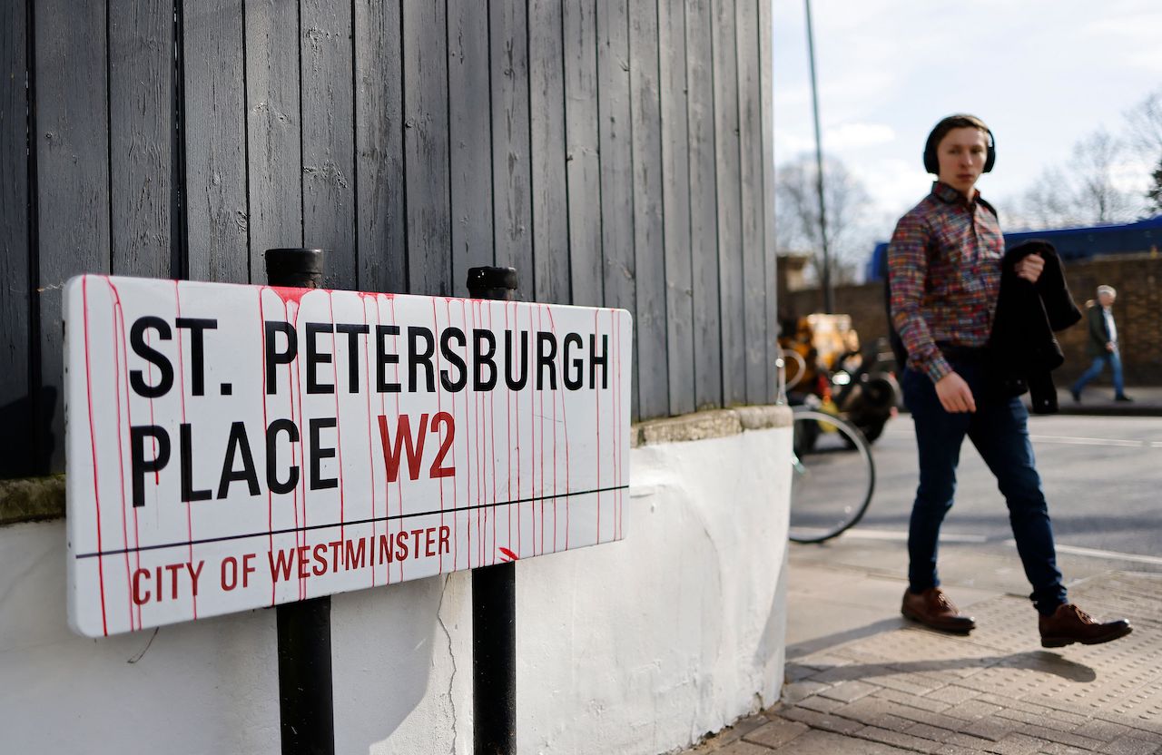 An street sign defaced with fake blood is pictured opposite the Russian Embassy in London, on February 26, 2022 during a protest rally following Russia's invasion of Ukraine