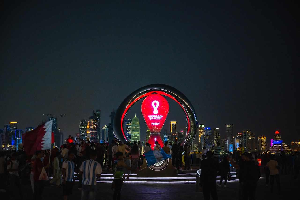 People gather for photos around the World Cup countdown clock in Doha ahead of the Qatar 2022 World Cup