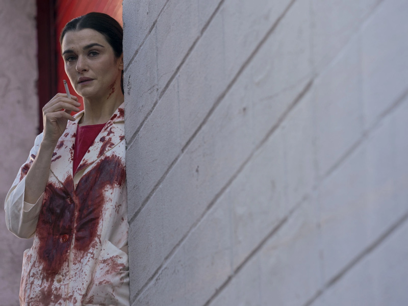 Szene aus der Serie: Eine Frau mit blutverschmiertem Kittel raucht eine Zigarette