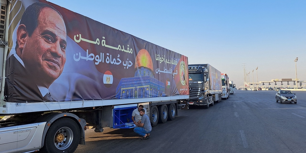 A convoy of trucks carrying aid supplies for Gaza from Egypt waits on the main Ismailia desert road, about 300 kms east of the Egyptian border with the Gaza Strip